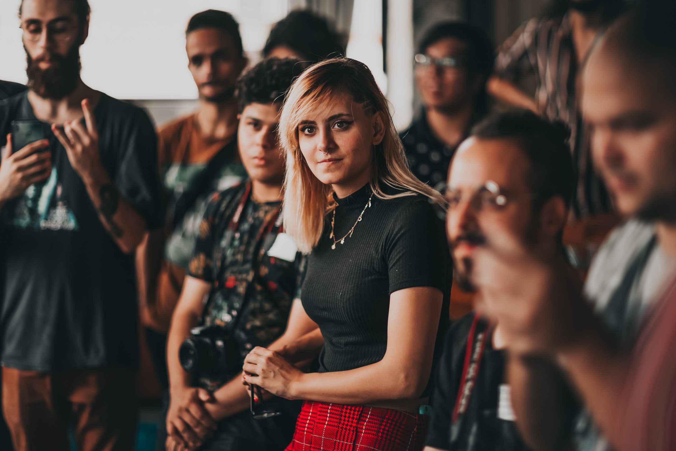 A group of office workers listening to someone. 