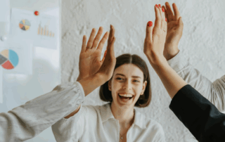 A team of co-workers doing a high five