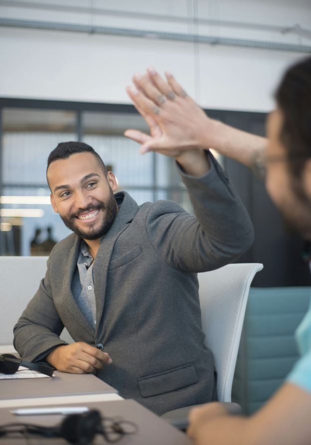 Two co-workers giving each other a high five