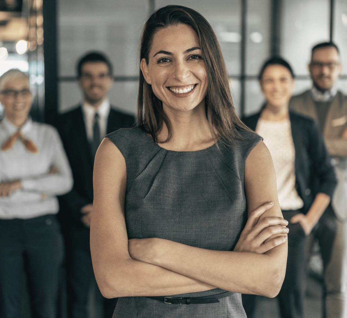 A leader smiling confidently in front of her team.